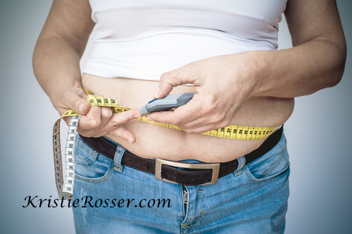 shutterstock_diabetes overweight measuring tape checking blood sugars_420054886